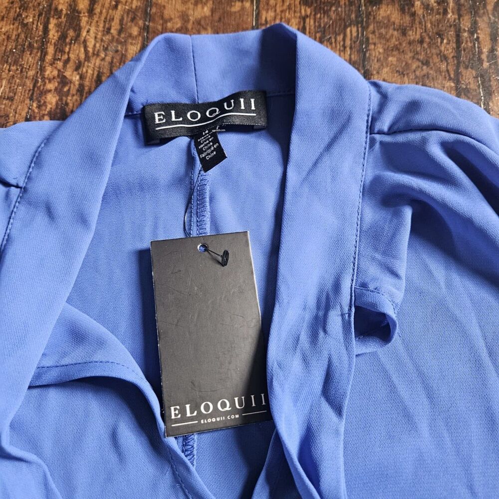 Eloquii blue tie-neck short-sleeve blouse V-neckline and relaxed flared sleeves.